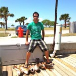 This fisherman proudly stands by the six fish he caught!